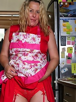 Cheery blonde in red fingering herself on the floor